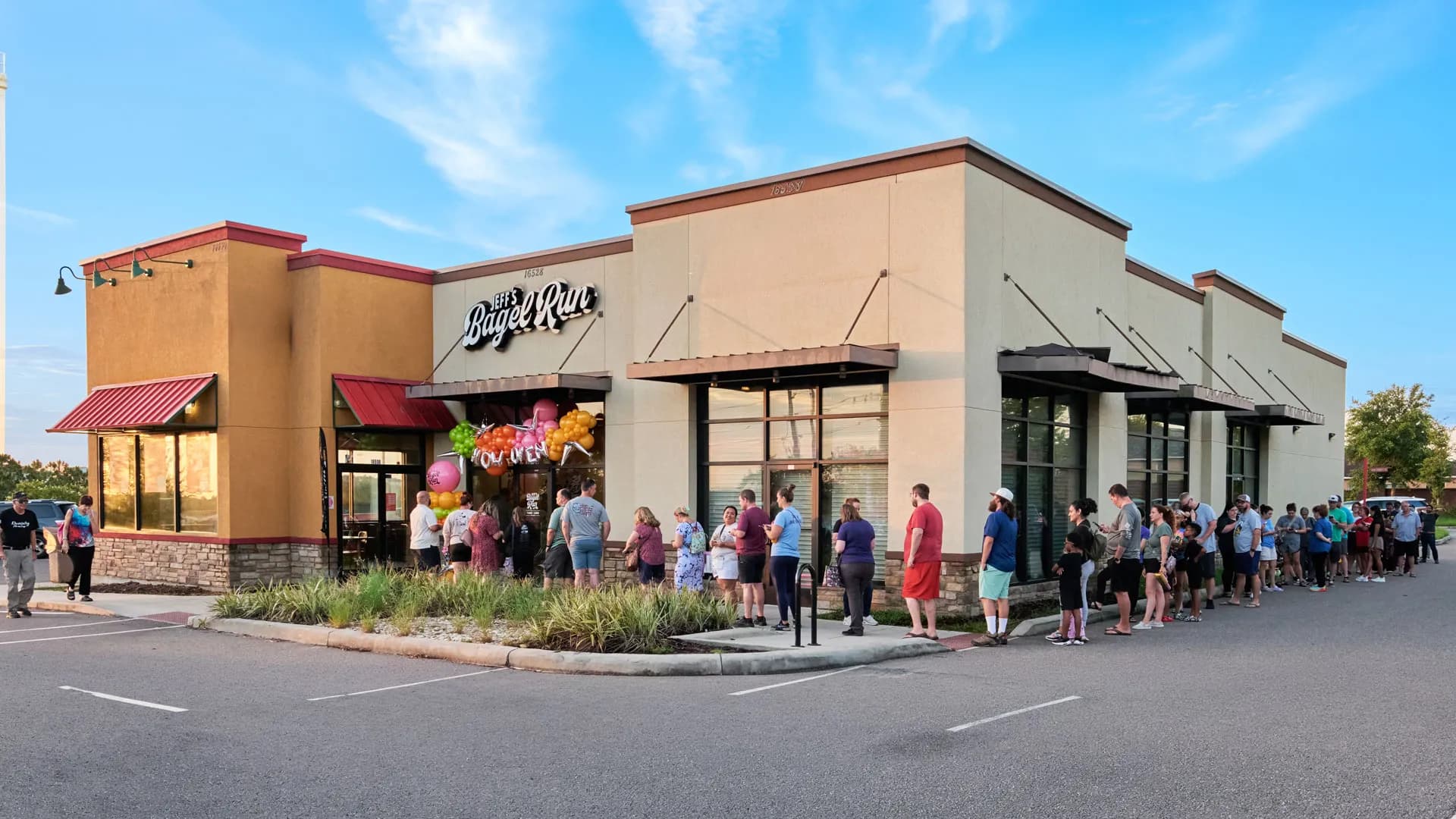 people standing outside Jeff's grand opening